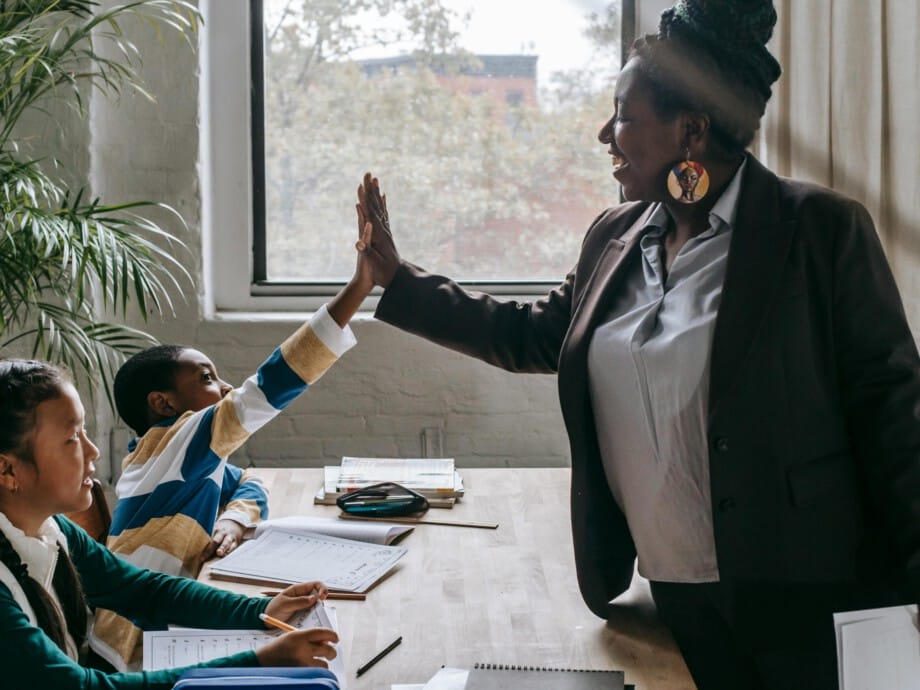Teacher high fiving student.